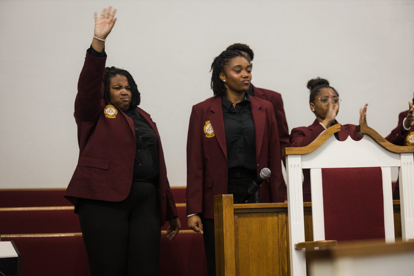 Choir in maroon robes worshipping at Allen Chapel AME