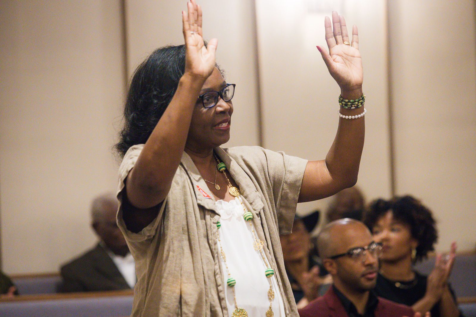 Church member with hands raised in worship