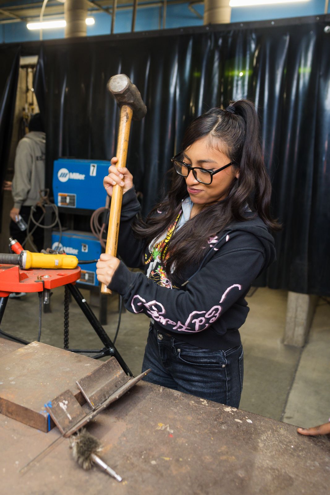 High school student learning pipefitting during a career exploration day