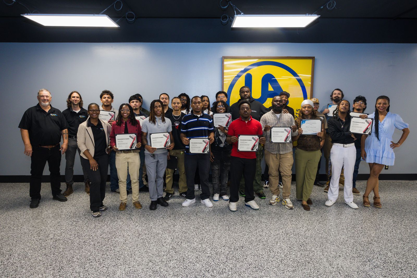 Career program graduates holding their certificates