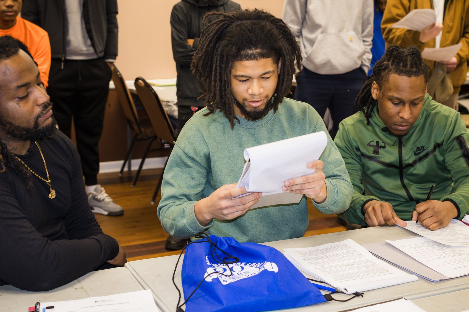 Career training students reviewing materials together