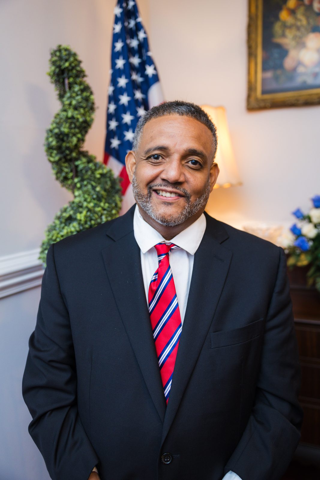 Brandon Brown in a navy suit and striped tie
