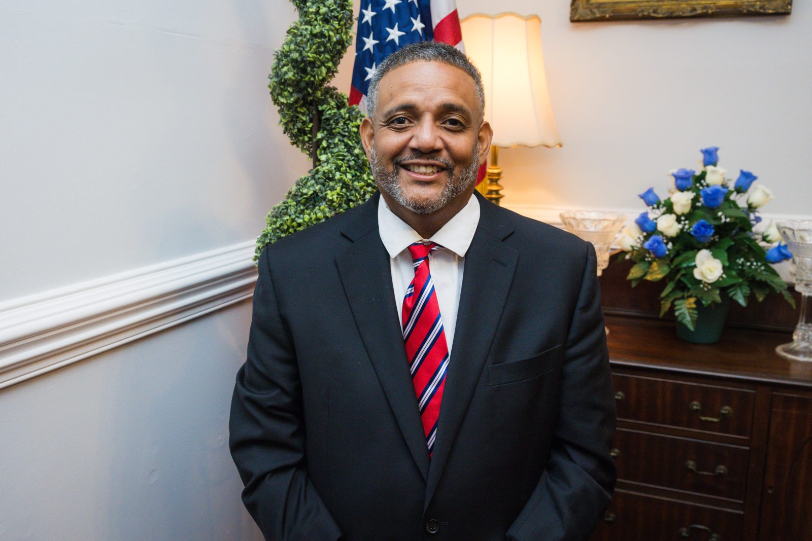 Brandon Brown smiling in a navy suit