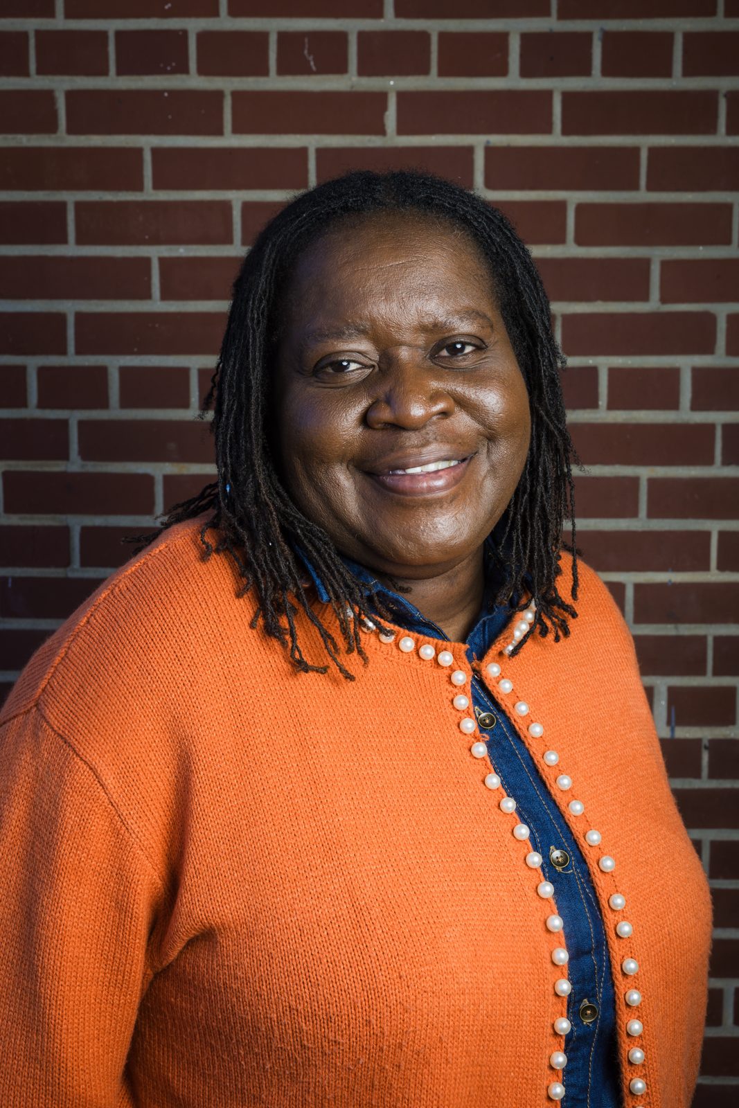 Fairfax Town Councilwoman Phyllis Smart smiling in an orange cardigan