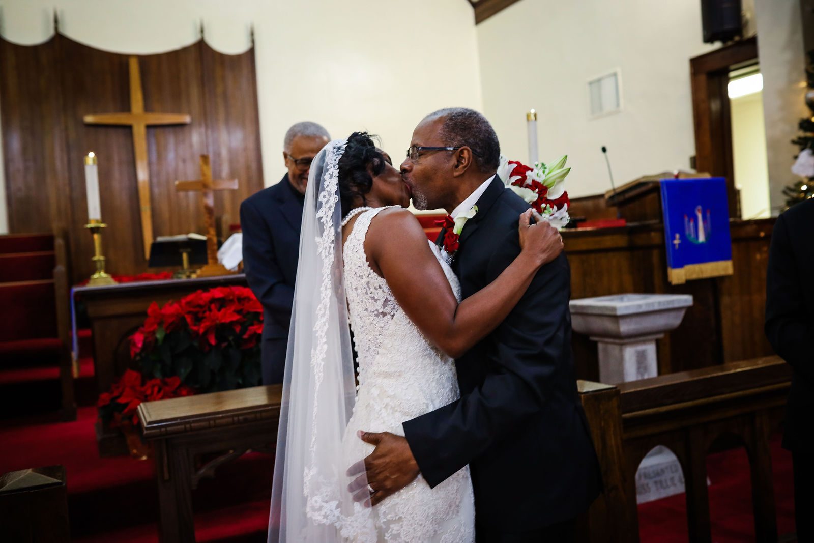 Bride and groom kiss at the church altar