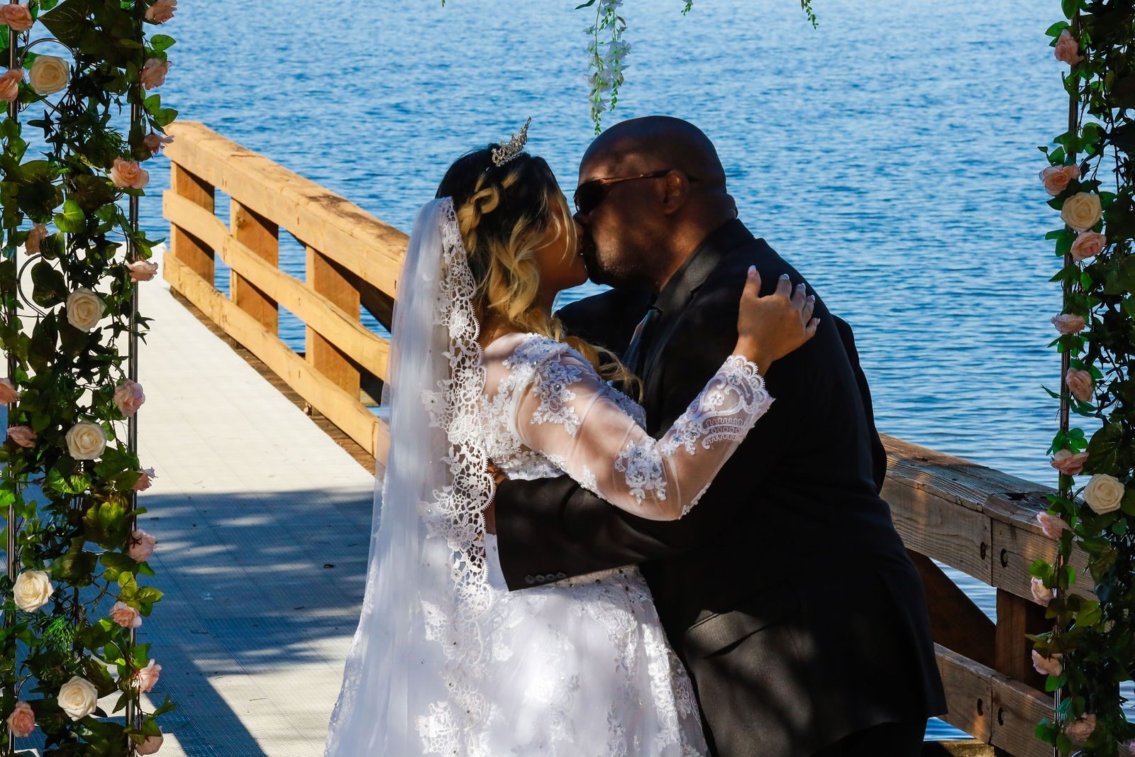 Bride and groom kiss on the dock