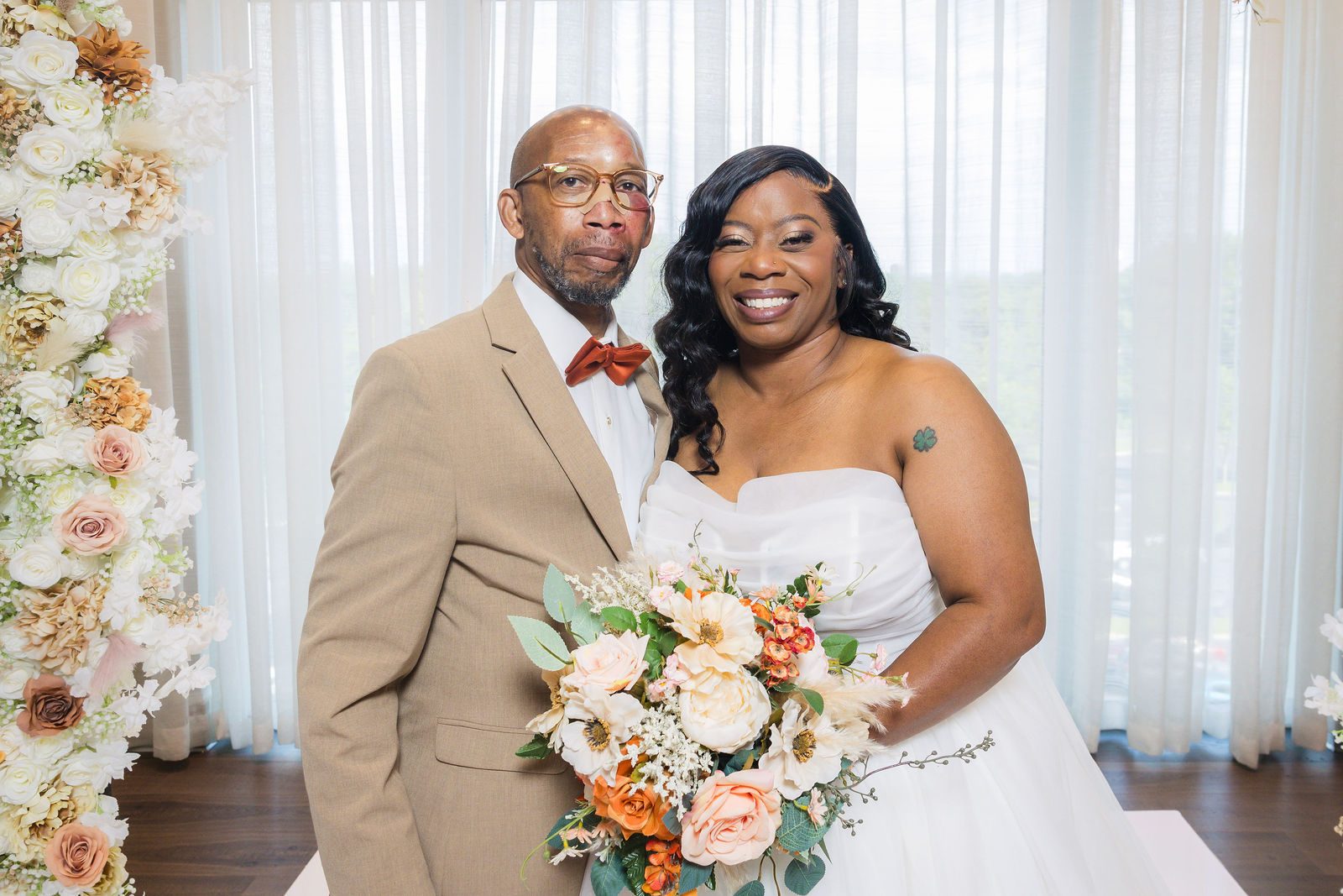 Tekisha and Newman portrait under the floral arch